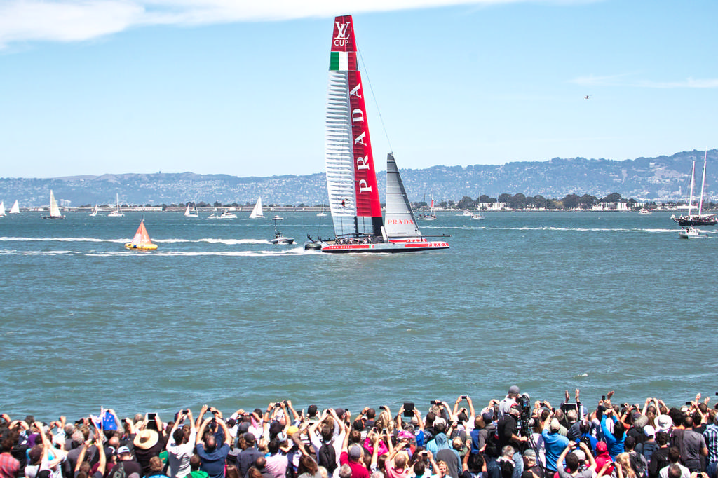 Luna Rossa crosses the finish line in front of spectators in the AC Village - America's Cup © Chuck Lantz http://www.ChuckLantz.com